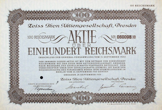 Altes deutsches Aktienzertifikat über Einhundert Reichmark mit schwarzem Rand und gedrucktem Text.