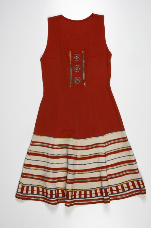 Ein leuchtend rotes Kleid mit weißen und gelben horizontalen Streifen vor einem weißen Hintergrund.