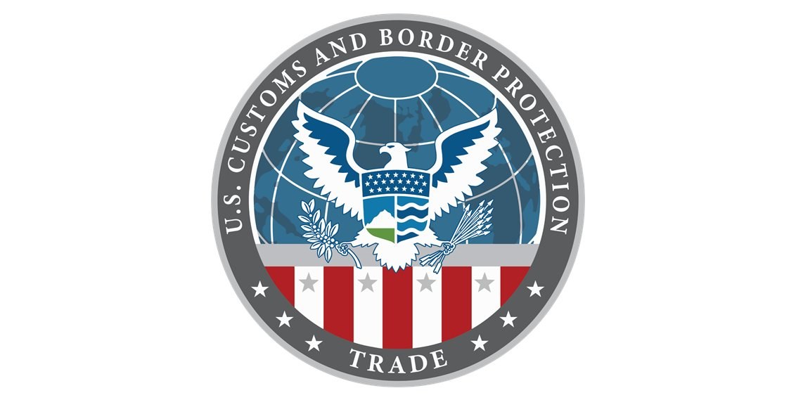 Logo der U.S. Zoll- und Grenzschutzbehörde Handel: ein blauer Kreis mit einem weißen Stern, einer weißen Taube mit ausgebreiteten Flügeln und dem Text "U.S." darüber.